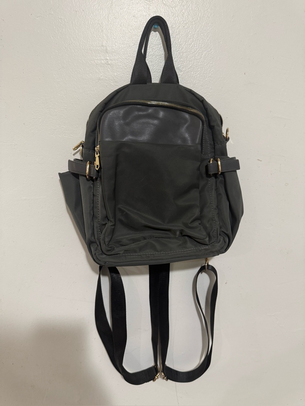 Compact Gray Backpack with Gold Hardware